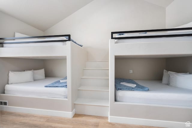bedroom featuring vaulted ceiling and wood finished floors