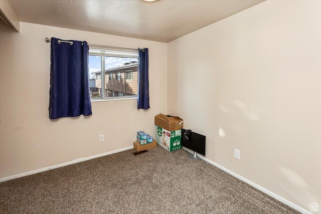 empty room with carpet floors and baseboards