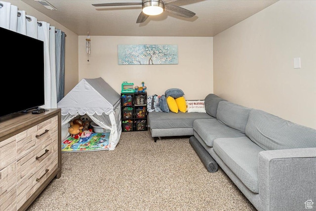 living area with light colored carpet, ceiling fan, and visible vents