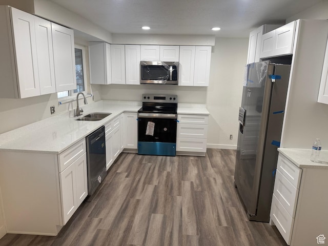 4129 S 3600 W, West Valley City, UT 84119 - kitchen with appliances with stainless steel finishes, dark wood finished floors, white cabinets, and a sink