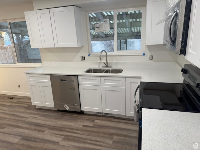 4129 S 3600 W, West Valley City, UT 84119 - kitchen featuring dark wood finished floors, stainless steel appliances, light countertops, white cabinets, and a sink