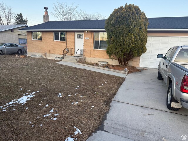 4129 S 3600 W, West Valley City, UT 84119 - ranch-style home featuring brick siding, a chimney, a shingled roof, a garage, and driveway