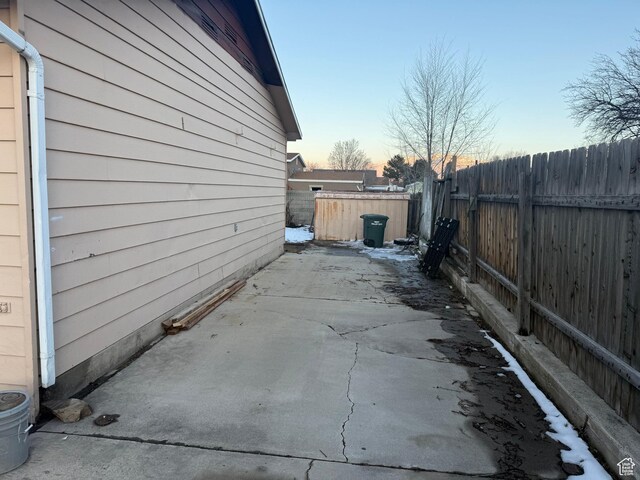4129 S 3600 W, West Valley City, UT 84119 - property exterior at dusk with a patio area and a fenced backyard