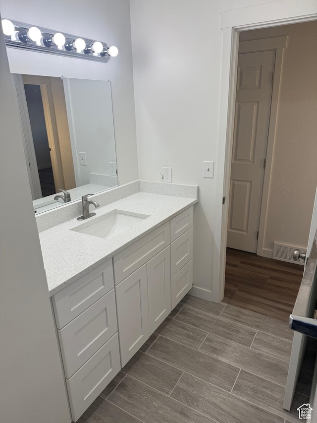 4129 S 3600 W, West Valley City, UT 84119 - bathroom with baseboards, vanity, visible vents, and wood tiled floor