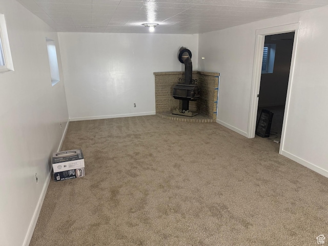 4129 S 3600 W, West Valley City, UT 84119 - unfurnished living room with carpet flooring, a wood stove, and baseboards