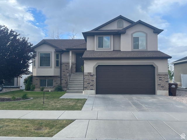 935 W 2100 N, Pleasant View, UT 84404 - view of front facade featuring brick siding, stucco siding, a garage, and a front lawn