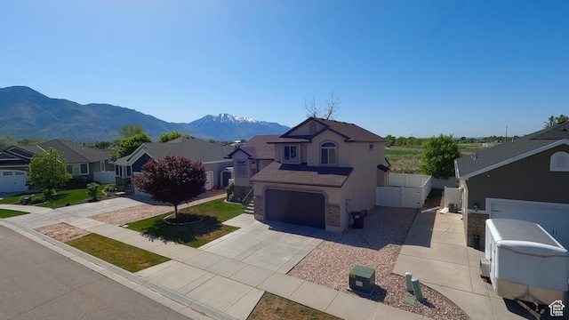935 W 2100 N, Pleasant View, UT 84404 - mediterranean / spanish-style house featuring concrete driveway, a residential view, stucco siding, a mountain view, and a garage