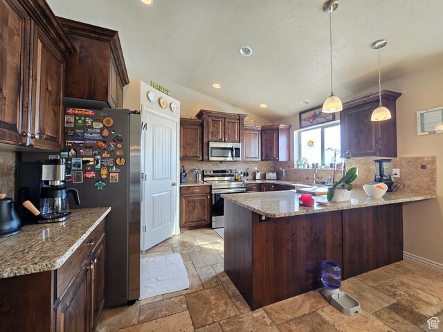 935 W 2100 N, Pleasant View, UT 84404 - kitchen featuring appliances with stainless steel finishes, stone tile floors, tasteful backsplash, a peninsula, and dark brown cabinetry