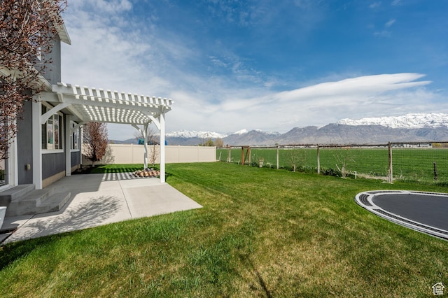1863 S 900 E, Lehi, UT 84043 - view of yard with a fenced backyard, a mountain view, a pergola, a trampoline, and a patio area