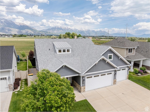 1863 S 900 E, Lehi, UT 84043 - view of front of house with stone siding, a mountain view, a garage, and a shingled roof