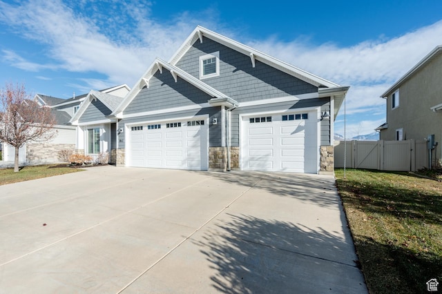 1863 S 900 E, Lehi, UT 84043 - view of front of house featuring a gate, stone siding, concrete driveway, fence, and an attached garage