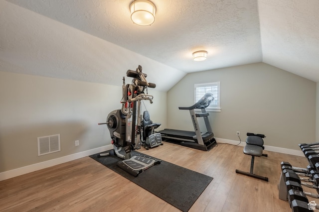 1863 S 900 E, Lehi, UT 84043 - exercise area featuring a textured ceiling, baseboards, visible vents, lofted ceiling, and wood finished floors