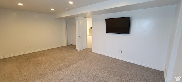 finished below grade area featuring recessed lighting, baseboards, and light colored carpet