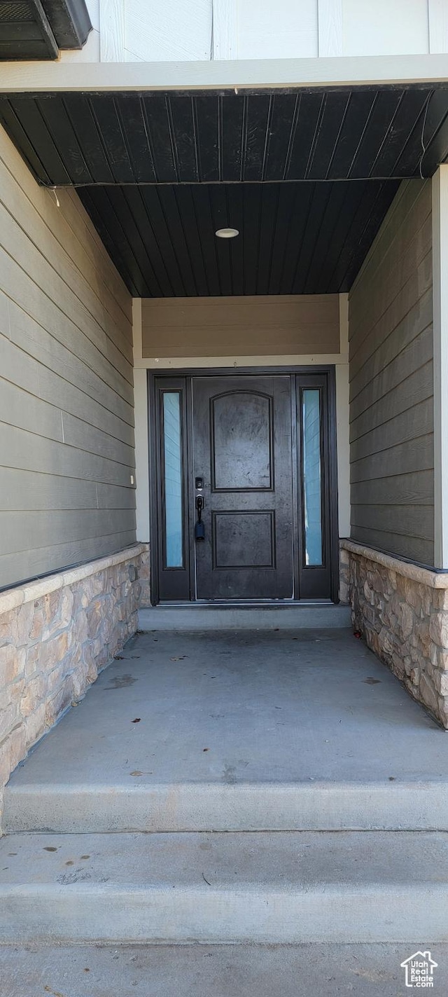 view of exterior entry with stone siding