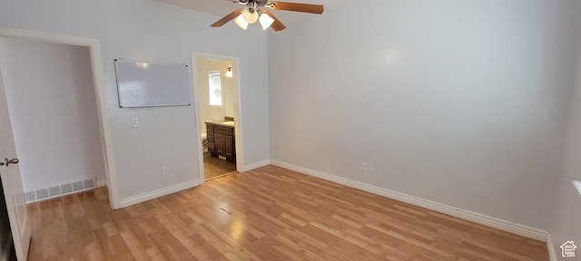 unfurnished bedroom featuring visible vents, baseboards, light wood-style floors, and ensuite bathroom