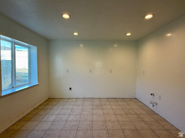spare room with light tile patterned flooring and recessed lighting