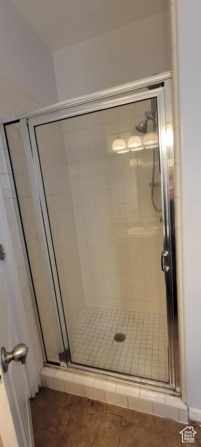 bathroom with tile patterned flooring and a stall shower