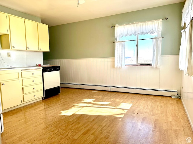 7998 E 5250 S, Randlett, UT 84063 - kitchen featuring dishwashing machine, a wainscoted wall, light countertops, baseboard heating, and light wood-type flooring