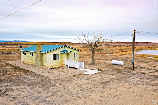 7998 E 5250 S, Randlett, UT 84063 - view of front of property featuring a water view, metal roof, and stucco siding