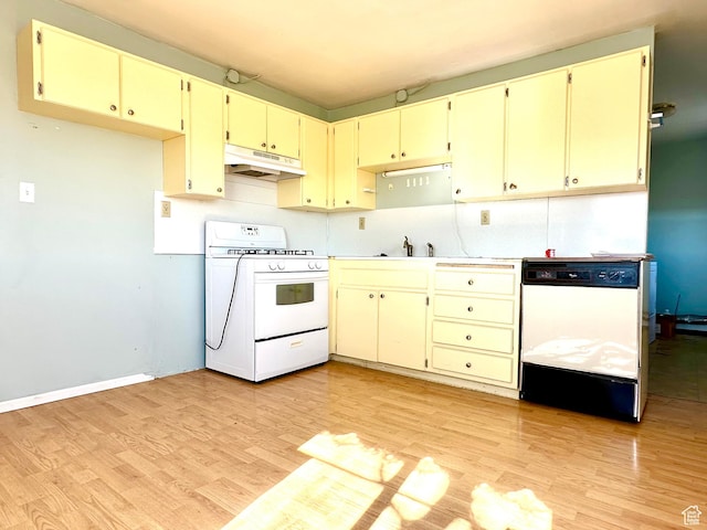 7998 E 5250 S, Randlett, UT 84063 - kitchen with under cabinet range hood, white appliances, light countertops, light wood-type flooring, and decorative backsplash