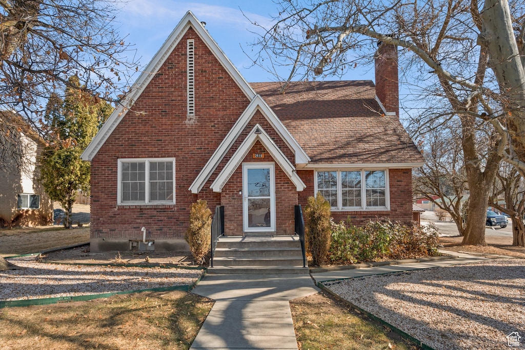 2810 N 450 E, North Ogden, UT 84414 - english style home with a shingled roof, a chimney, and brick siding