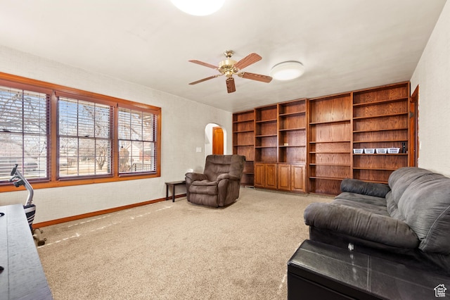 2810 N 450 E, North Ogden, UT 84414 - carpeted living area with arched walkways, a ceiling fan, and baseboards