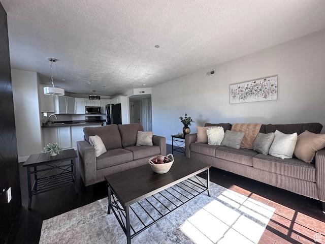 196 E Spencer Peak Way E Unit D6, Draper, UT 84020 - living room featuring a textured ceiling and baseboards