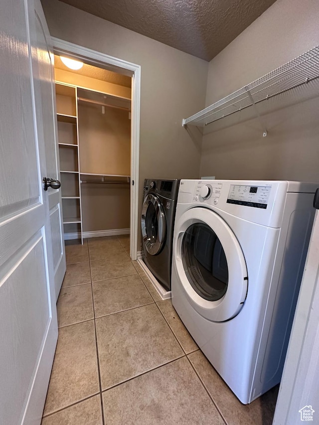 196 E Spencer Peak Way E Unit D6, Draper, UT 84020 - washroom with light tile patterned floors, independent washer and dryer, and a textured ceiling