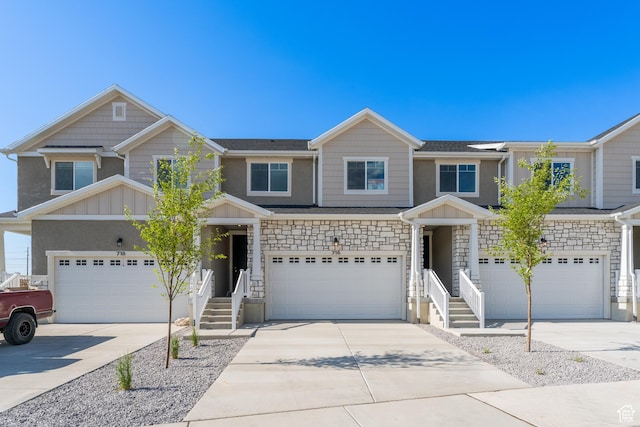 716 W 4500 S Unit 302, Mapleton, UT 84664 - view of front of home with board and batten siding, concrete driveway, an attached garage, and stone siding