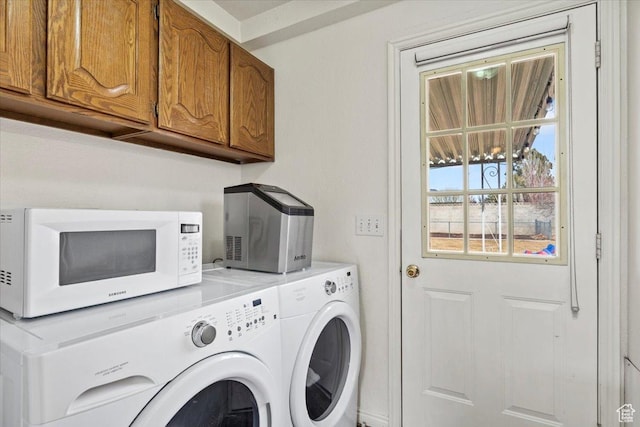 laundry room featuring washer and dryer and cabinet space