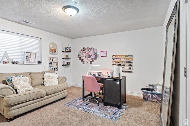 carpeted office with a textured ceiling and baseboards