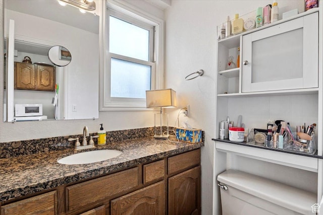 bathroom featuring vanity and toilet