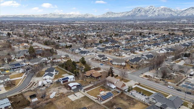 aerial overview of property's location with a mountainous background and nearby suburban area