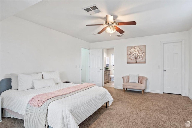 bedroom featuring light carpet, baseboards, ensuite bath, and a ceiling fan