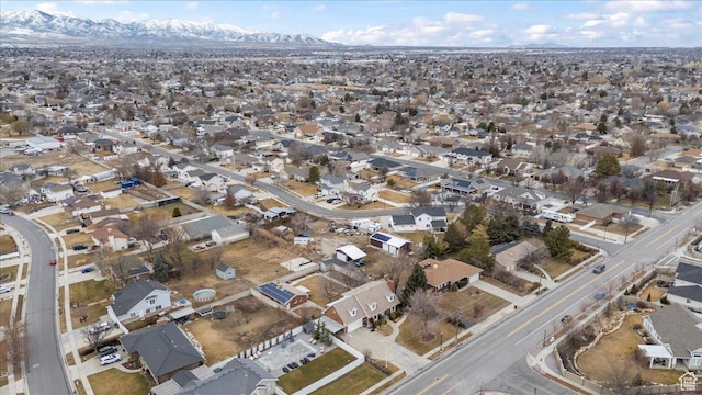 aerial view of property and surrounding area featuring a mountainous background and nearby suburban area