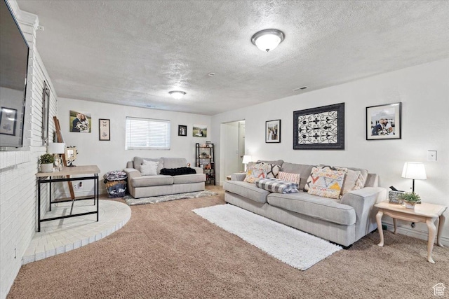 carpeted living area featuring a textured ceiling