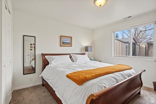 bedroom featuring baseboards and carpet