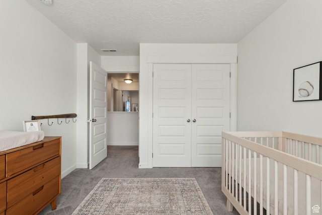 4473 E Hurstbourne Dr, Eagle Mountain, UT 84005 - carpeted bedroom featuring a crib, visible vents, baseboards, a textured ceiling, and a closet