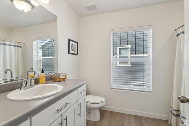 4473 E Hurstbourne Dr, Eagle Mountain, UT 84005 - bathroom with visible vents, toilet, vanity, wood finished floors, and baseboards