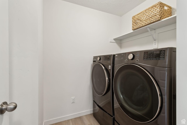 4473 E Hurstbourne Dr, Eagle Mountain, UT 84005 - clothes washing area with light wood-type flooring, laundry area, baseboards, and washer and dryer