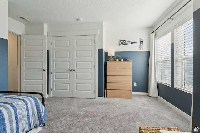 4473 E Hurstbourne Dr, Eagle Mountain, UT 84005 - bedroom with a closet, visible vents, light carpet, and a textured ceiling