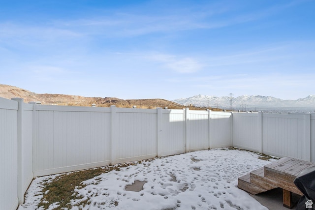 4473 E Hurstbourne Dr, Eagle Mountain, UT 84005 - yard covered in snow with a fenced backyard and a mountain view