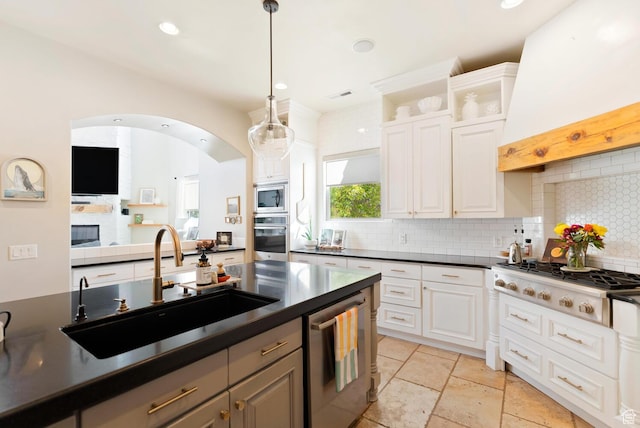802 Leda Ln, Santa Clara, UT 84765 - kitchen with white cabinets, dark countertops, appliances with stainless steel finishes, custom exhaust hood, and a sink