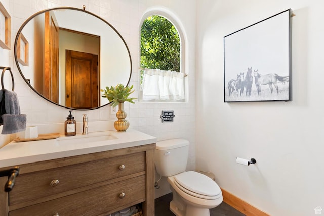802 Leda Ln, Santa Clara, UT 84765 - half bathroom featuring baseboards, tile walls, toilet, vanity, and backsplash