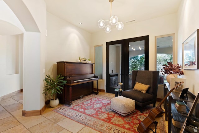 802 Leda Ln, Santa Clara, UT 84765 - living area with visible vents, baseboards, arched walkways, stone tile flooring, and french doors