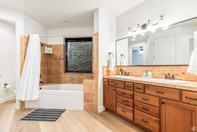 802 Leda Ln, Santa Clara, UT 84765 - bathroom featuring double vanity, a sink, decorative backsplash, and wood finished floors