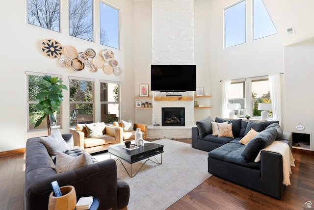 802 Leda Ln, Santa Clara, UT 84765 - living room with baseboards, visible vents, dark wood-style flooring, and a stone fireplace