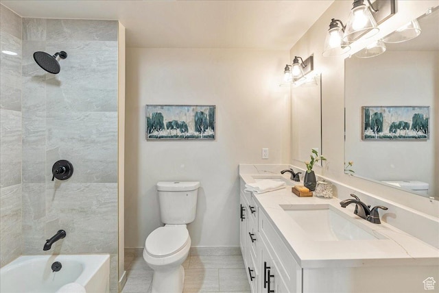 bathroom featuring toilet, double vanity, baseboards, and a sink