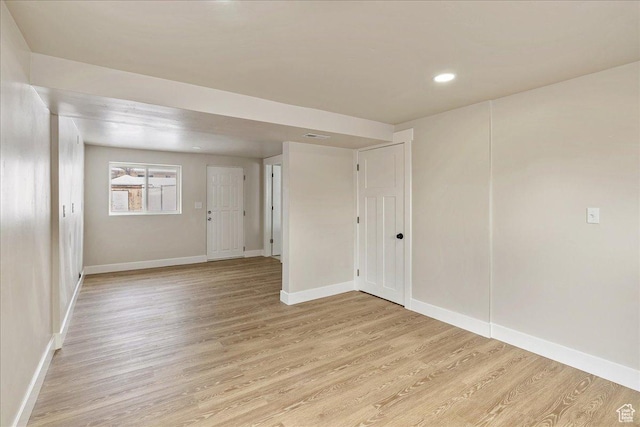 empty room with recessed lighting, baseboards, and light wood finished floors