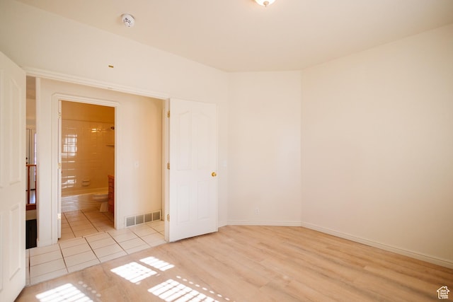 524 S Oak Ln W Unit 3, Tooele, UT 84074 - spare room featuring light wood-type flooring, baseboards, and visible vents